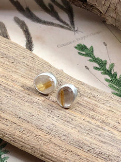 Dazzling golden streaks trail through faceted quartz in these gorgeous studs, perfect for everyday wear or dressing up your updo.

Product Details:

• Rose cut rutilated quartz
• Solid sterling silver posts and clutches