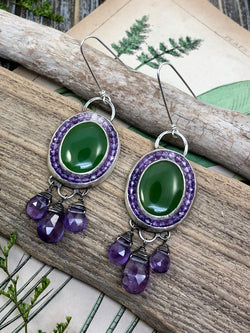 So bold, so beautiful, the combination of purple and green has always been my favorite.  Since I was twelve years old and crafted my very first pair of earrings in this color combination with wooden beads, I have always thought purple and green were the perfect pair.  Ovals of nephrite jade are surrounded by halos of ombre faceted amethyst gems ranging from pale pink to deep purple. Accented with hand stamping and six faceted amethyst teardrops, these earrings are finished on extra lon