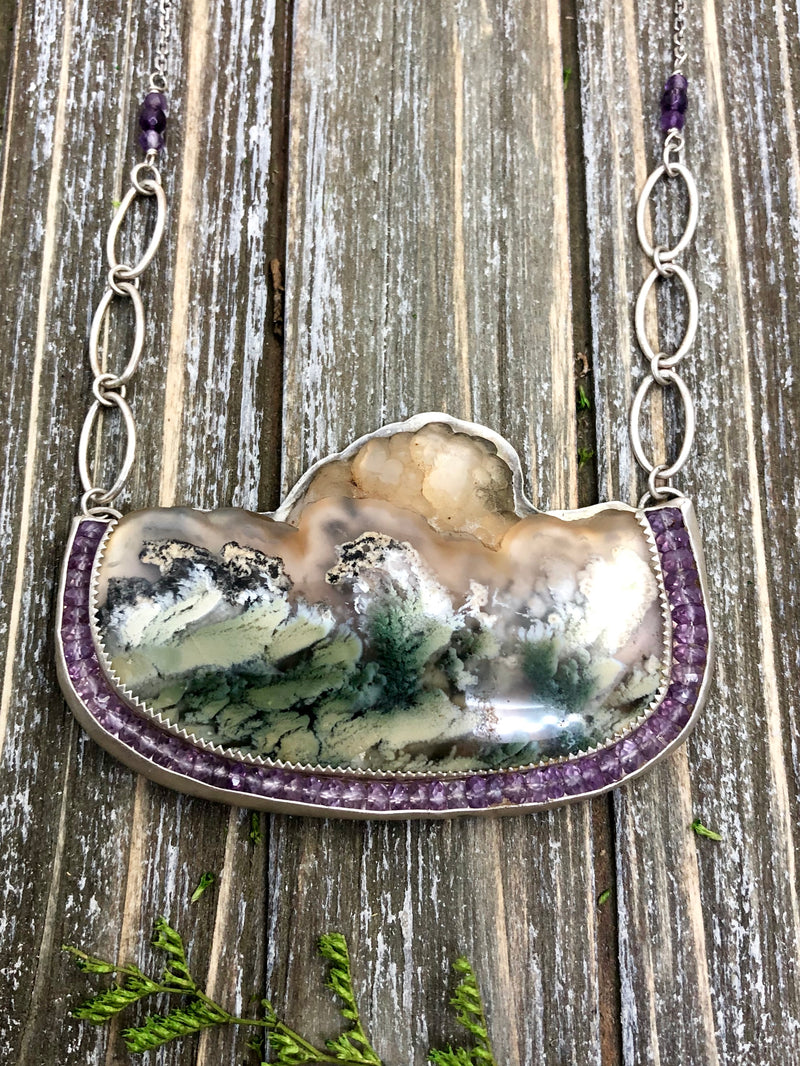 The sea is fierce, but you are brave.  Even if you forget sometimes, this bold pendant will remind you of your courage. The earth is a magical place.  It is tumultuous, but it is full of wonder.  How can a whole story fit into one rock? An absolutely stellar piece of moss agate is accented by lavender amethyst gems and handmade chain.  YOU ARE BRAVE is hand stamped on the reverse side.  Handcrafted from sterling silver.

Product Details:

• Indonesian scenic moss agate
• 52 lavender am