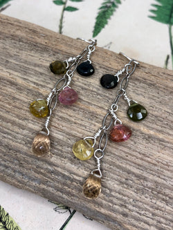A beautiful color palette of pinks and yellows with a splash of green gives these cascade earrings a unique quality. Hand wire-tied in sterling and finished on standard length French wires.

• 8 - tourmaline briolettes 
• 2 - citrine briolettes 
• Oxidized oval sterling chain 
• Sterling French wires 
• 2” from the hook in length