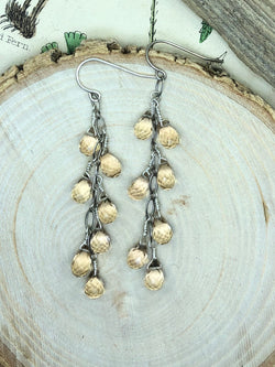 14 micro-faceted golden yellow citrine briolettes are expertly wire-tied and displayed on oval oxidized sterling chain. Elegant enough for an evening out or something to spruce up your everyday ensemble.

• 14 - microfaceted citrine briolettes 
• Oxidized sterling oval chain
• Sterling French wires 
• 2.5” from the hook