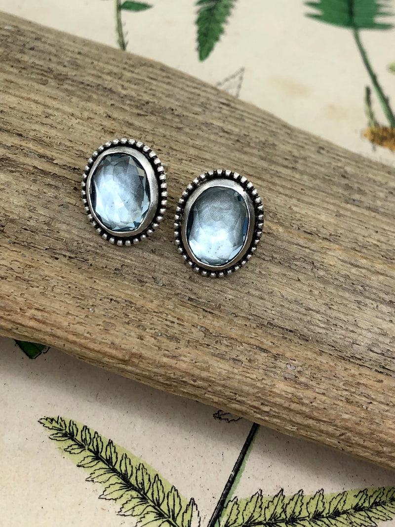 Newness can feel a little intimidating. We all need a little help, a little magic perhaps.

What could elicit spring better than the most delicate and etherial blue of aquamarine? Welcome the feeling of spring’s promise of new beginnings and renewed energy with these fabulous earring studs. Skillfully framed in silver bezels and beaded surround. Great for any time of year that you need a fresh and confident look.

•Aquamarine gems
•Fine and sterling silver
