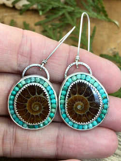 "Compassion is an action word with no boundaries" - Prince

Recall primeval oceans with these stunning ammonite fossils. Rich amber to golden honey-colored fossil slices are perfectly set off by surrounding American-mined turquoise gems. These show-stoppers are set in hand-fabricated silver settings with extra long French ear wires. 

Product Details:

• Extra-long sterling silver ear wires
• Two Ammonite fossils
• Faceted American-mined turquoise gems
• Sterling and fine silver
• Just